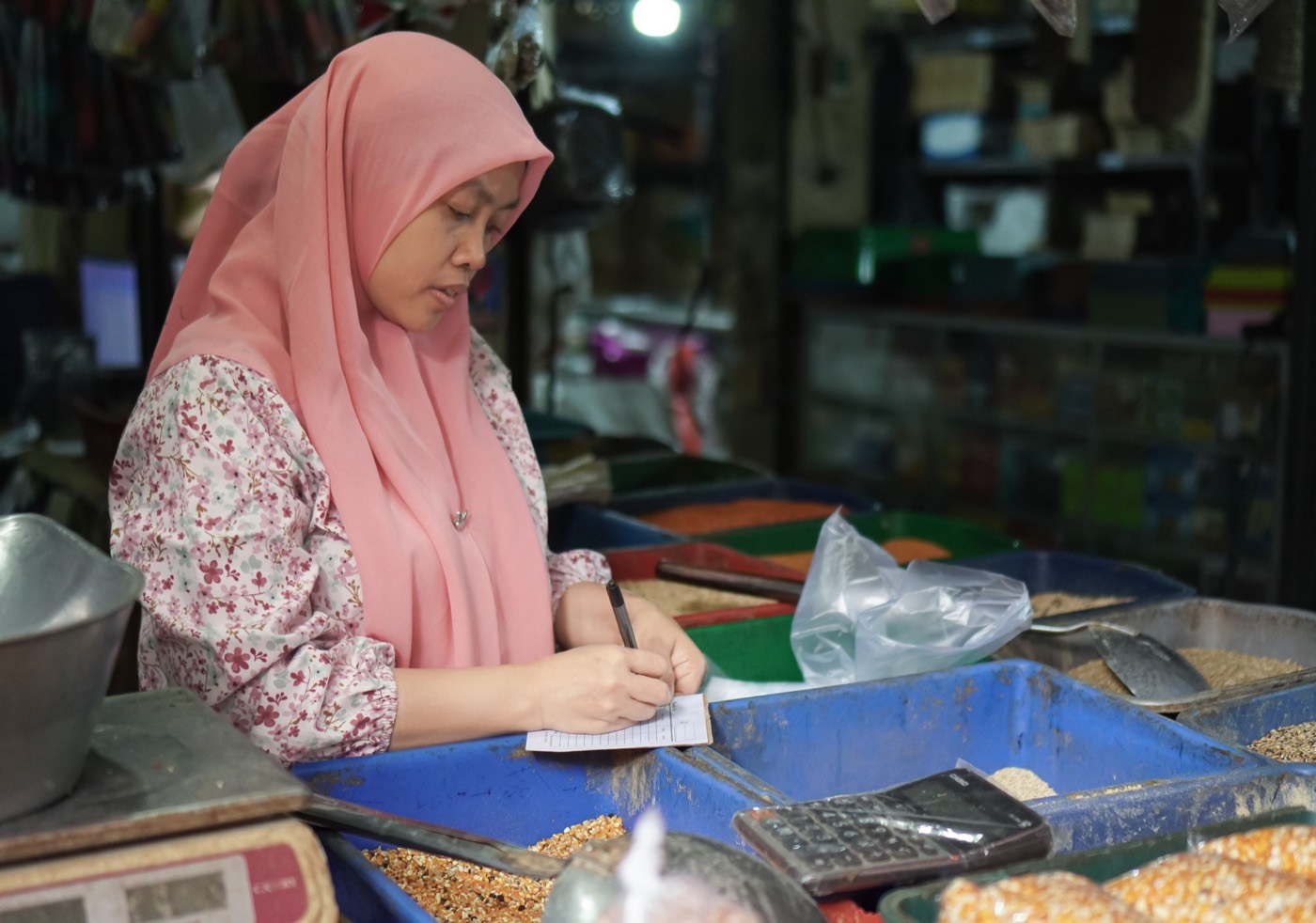 A market vendor calculating her sales